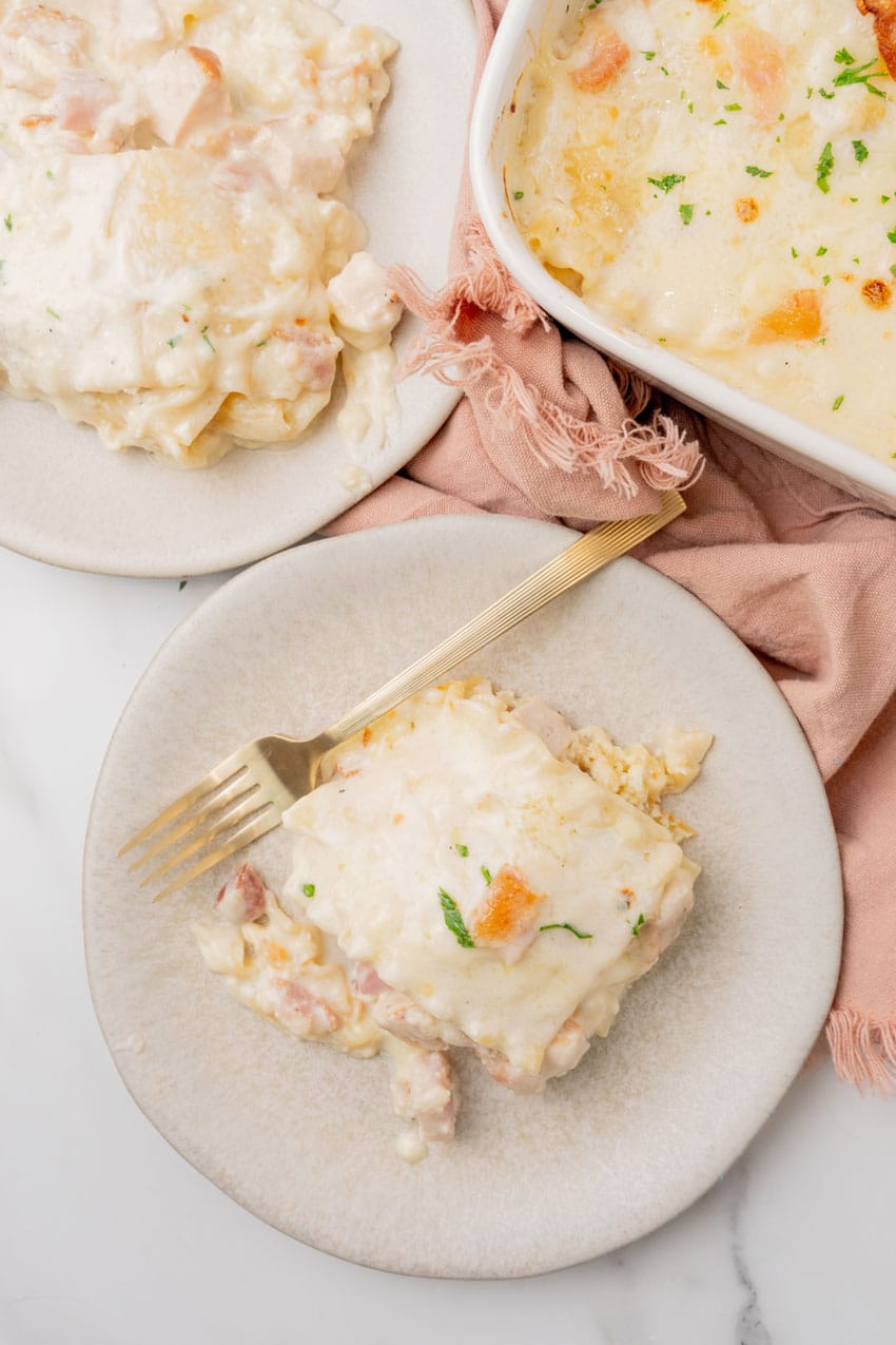 a slice of chicken cordon bleu lasagna on a white plate