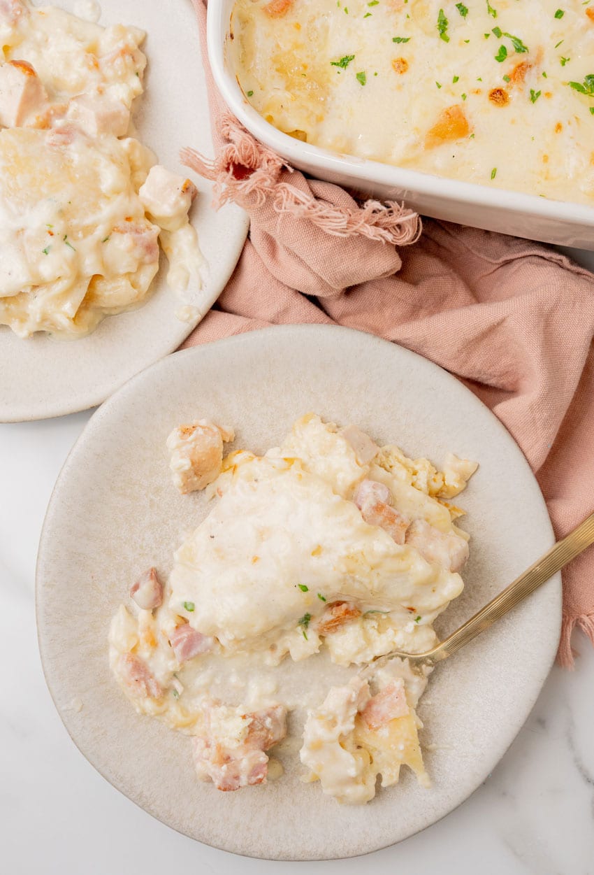 a slice of chicken cordon bleu lasagna on a white plate