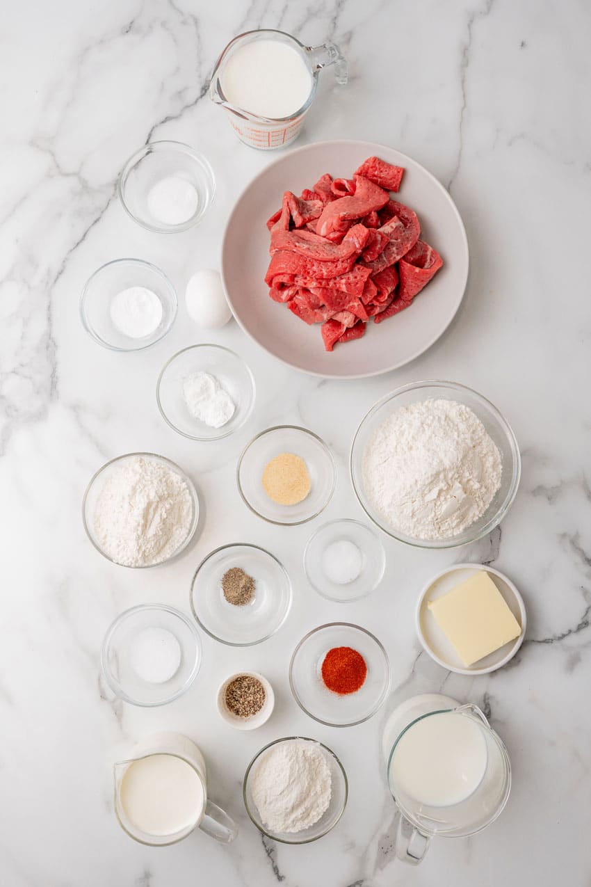an overhead image showing the measured ingredients needed to make a batch of chicken fried steak fingers