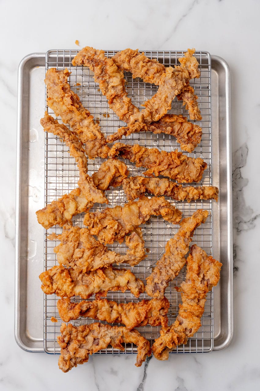 chicken fried steak fingers on a wire rack