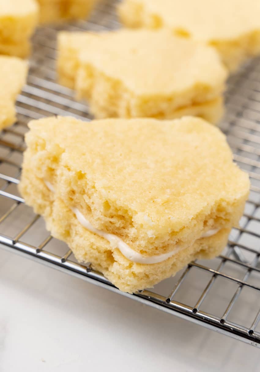 marshmallow stuffed small christmas tree shaped cakes on a wire rack