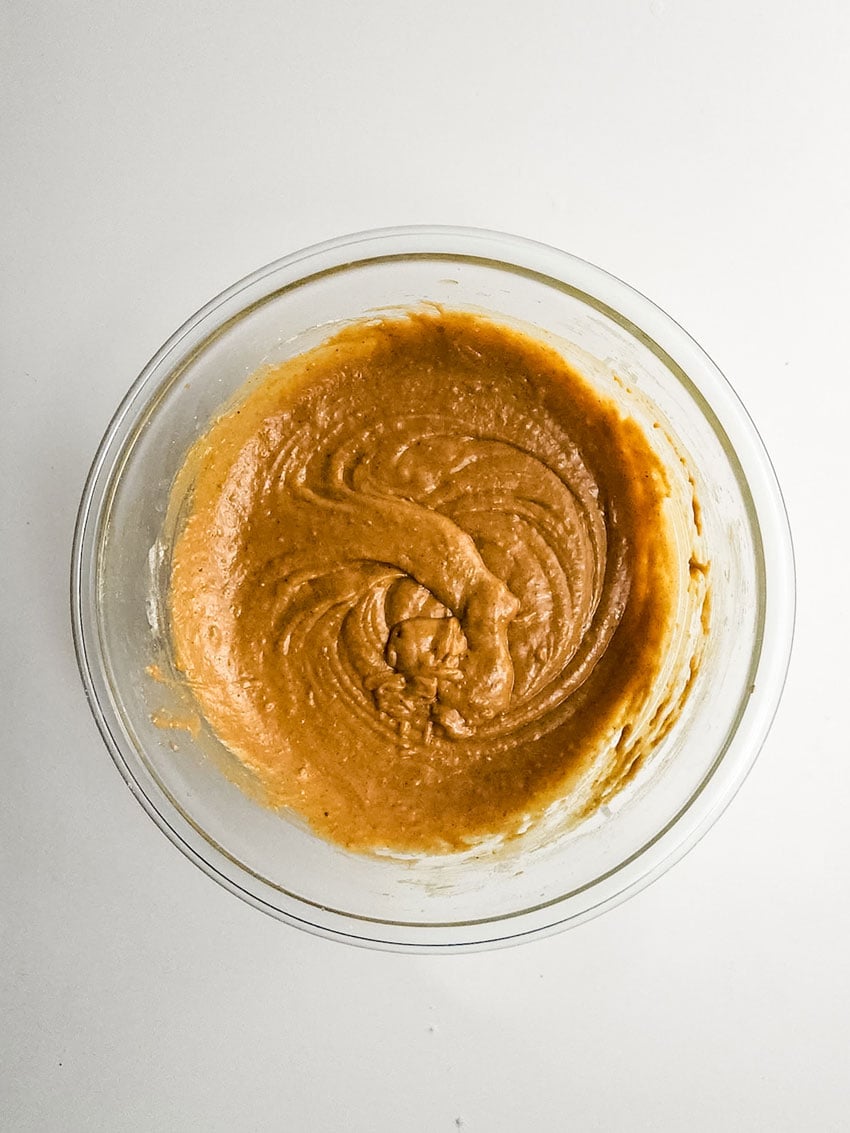 sweet potato cupcake batter in a glass mixing bowl