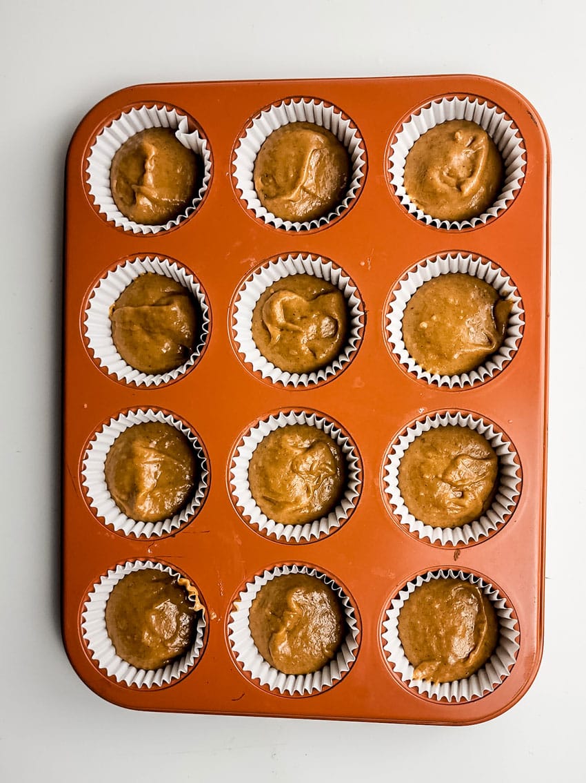 sweet potato cupcake batter in paper lined muffin tin wells
