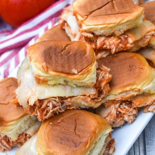 crockpot chicken parmesan sliders stacked on a white serving platter