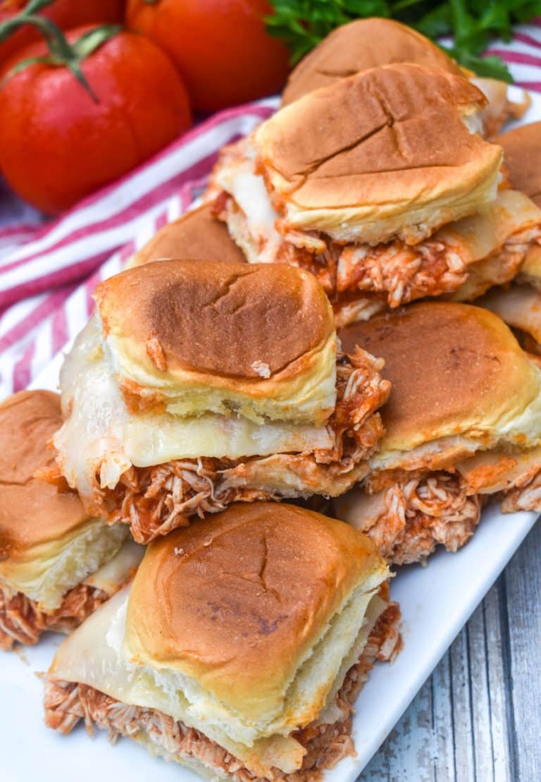 crockpot chicken parmesan sliders stacked on a white serving platter