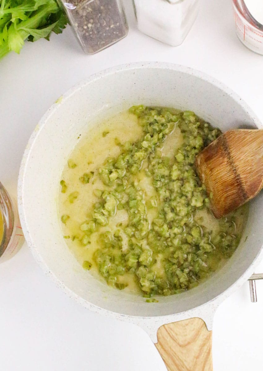 diced celery and melted butter in a small white sauce pot