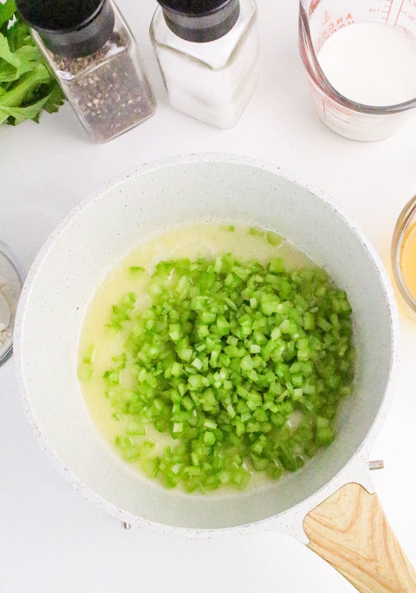 diced celery and melted butter in a small white sauce pot
