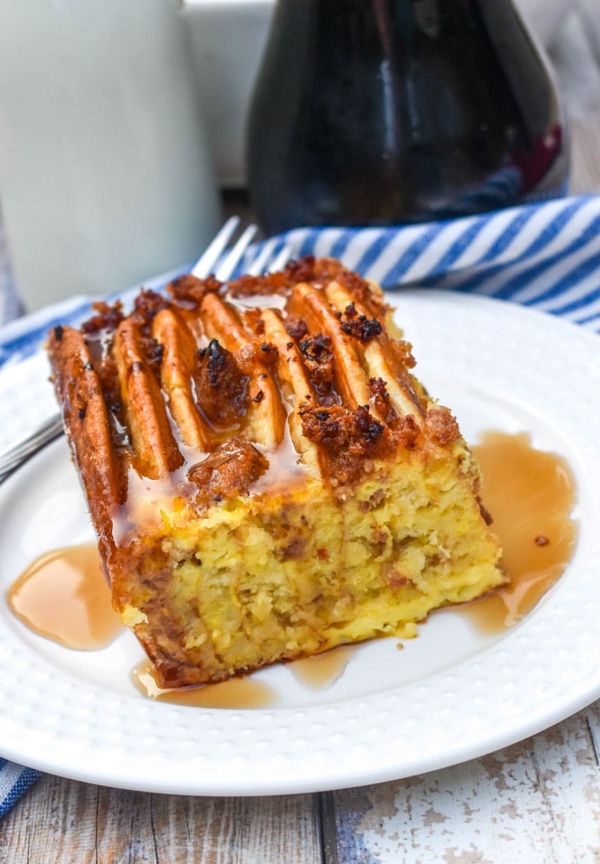 a slice of sausage and pancake casserole on a small white plate