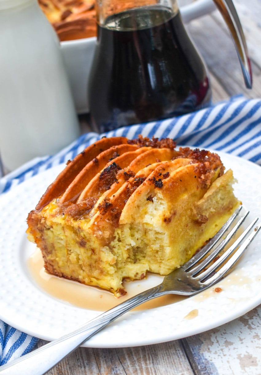 a slice of sausage and pancake casserole on a small white plate