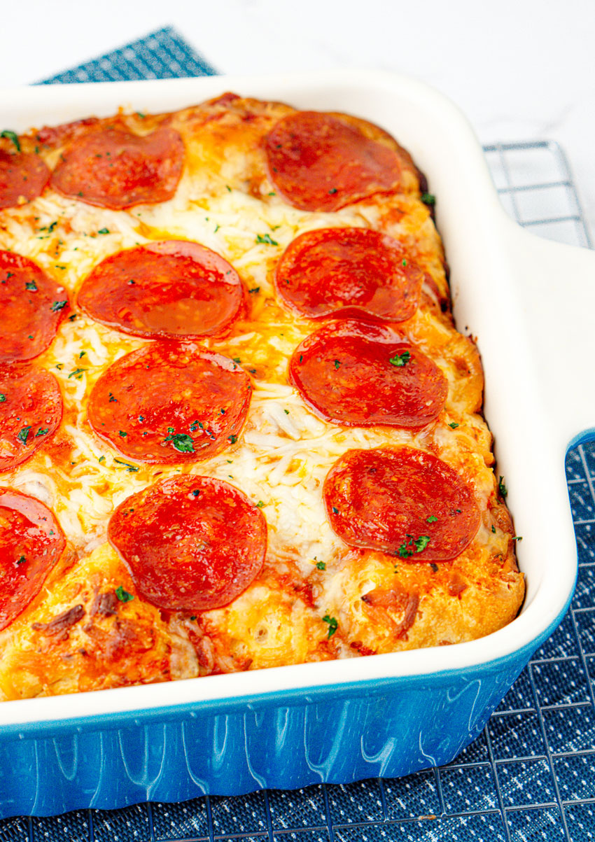 bubble up pizza casserole in a blue baking dish