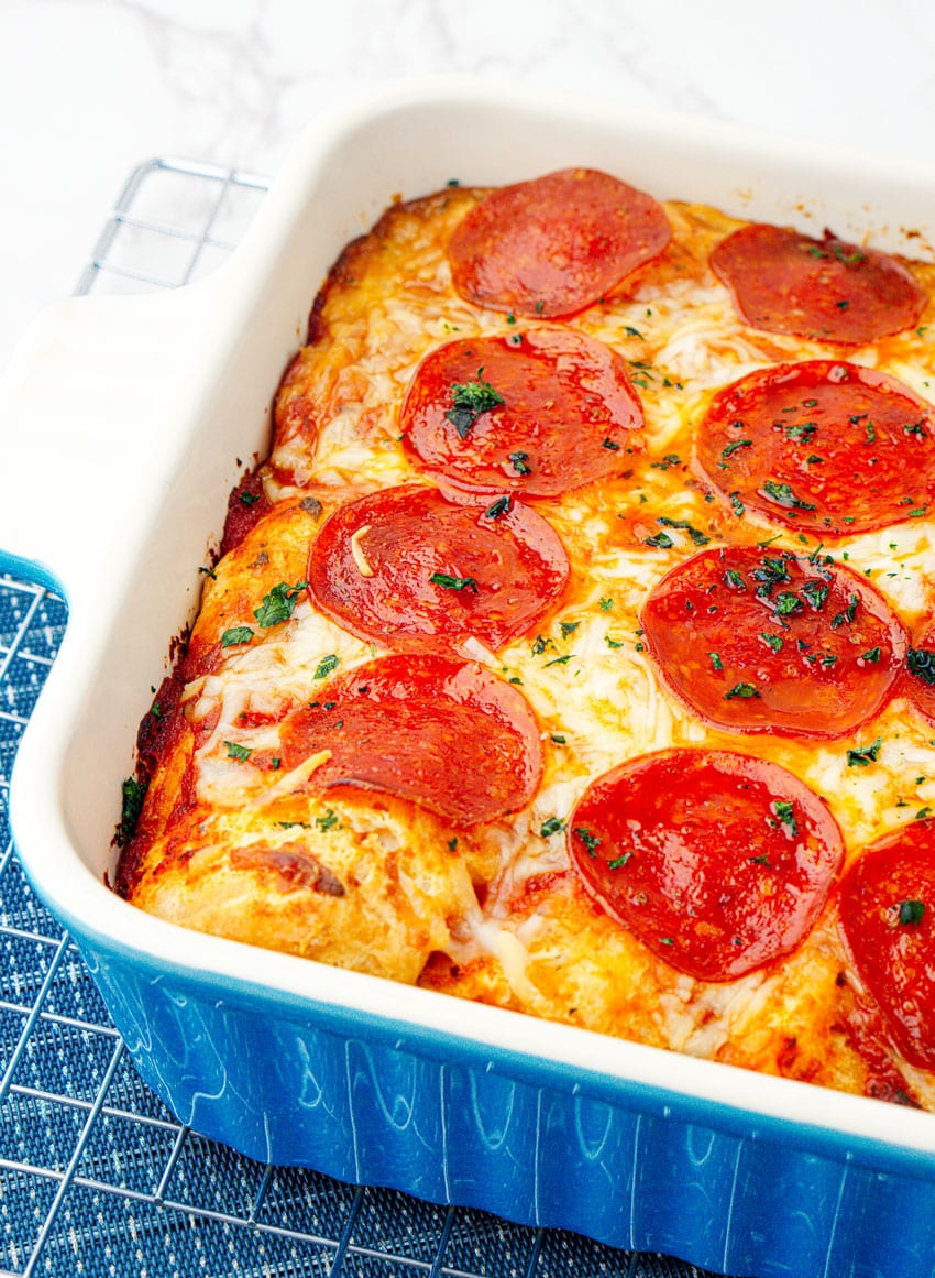 bubble up pizza casserole in a white baking dish