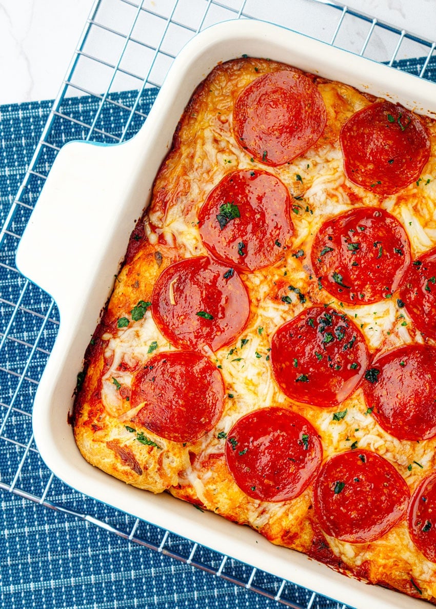 bubble up pizza casserole in a white baking dish