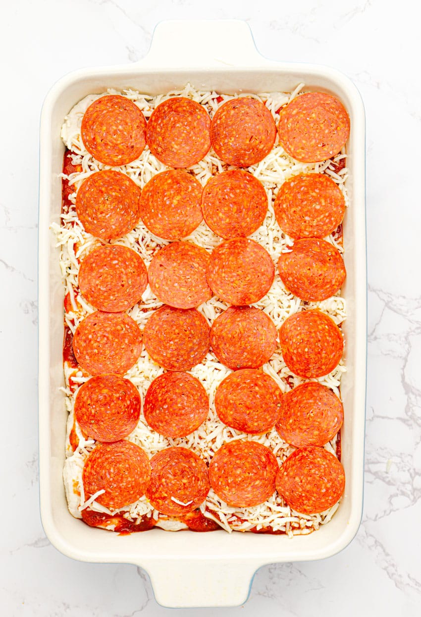 bubble up pizza casserole in a white baking dish