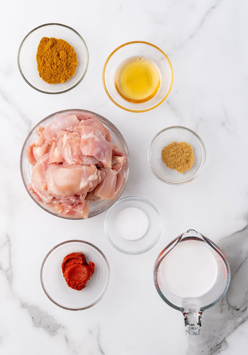 an overhead image showing the measured ingredients needed to make chicken satay skewers at home