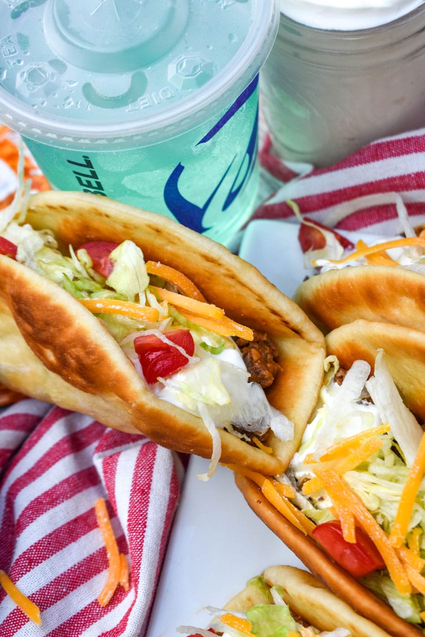 homemade beef chalupas arranged in a row on a white serving platter
