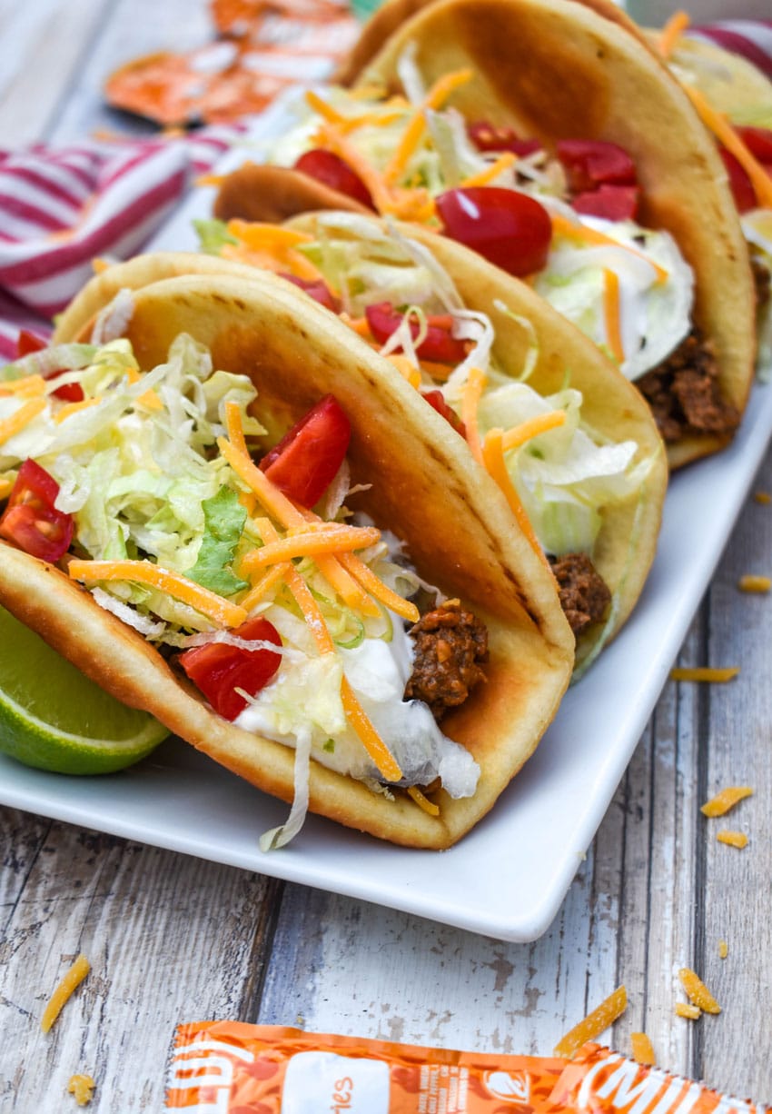 homemade beef chalupas arranged in a row on a white serving platter