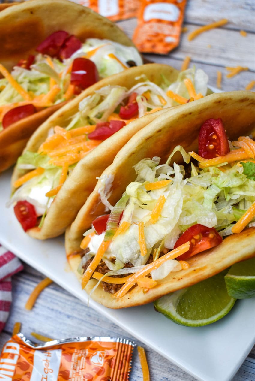 homemade beef chalupas arranged in a row on a white serving platter