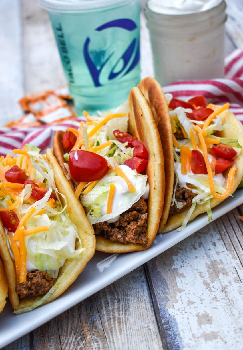 homemade beef chalupas arranged in a row on a white serving platter