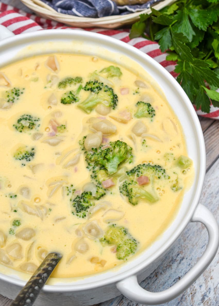 boxed macaroni and cheese soup with ham and broccoli in a large white serving bowl