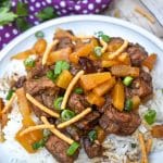 slow cooker steak teriyaki over steamed white rice on a white plate