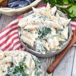 spinach dip pasta salad in two small gray bowls