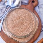 easy cinnamon sugar in a small glass jar on a small wooden coaster