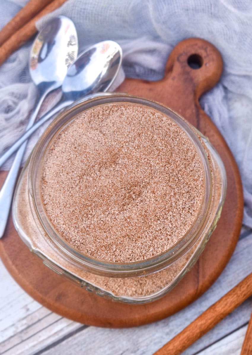 easy cinnamon sugar in a small glass jar on a small wooden coaster