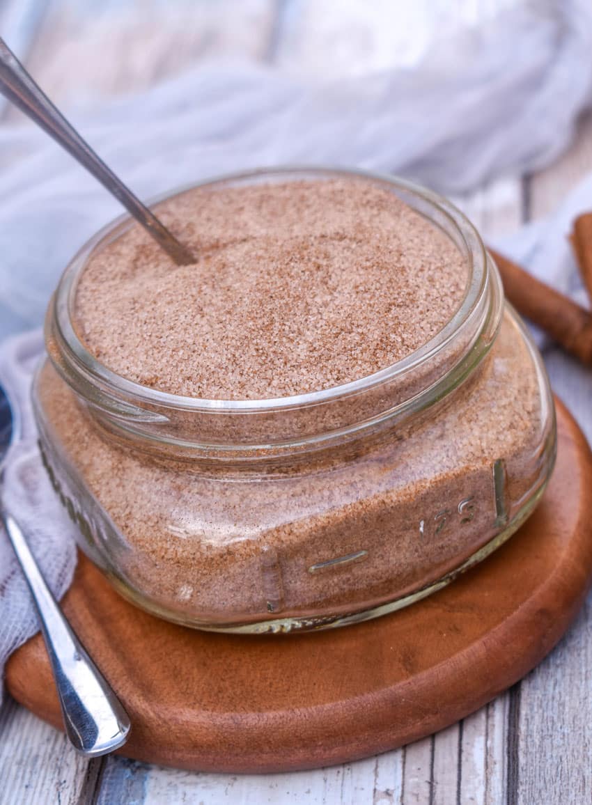 easy cinnamon sugar in a small glass jar on a small wooden coaster