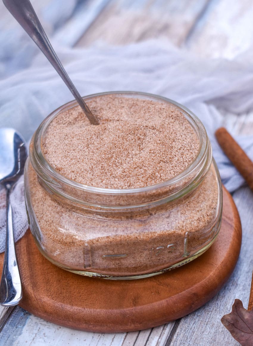 easy cinnamon sugar in a small glass jar on a small wooden coaster