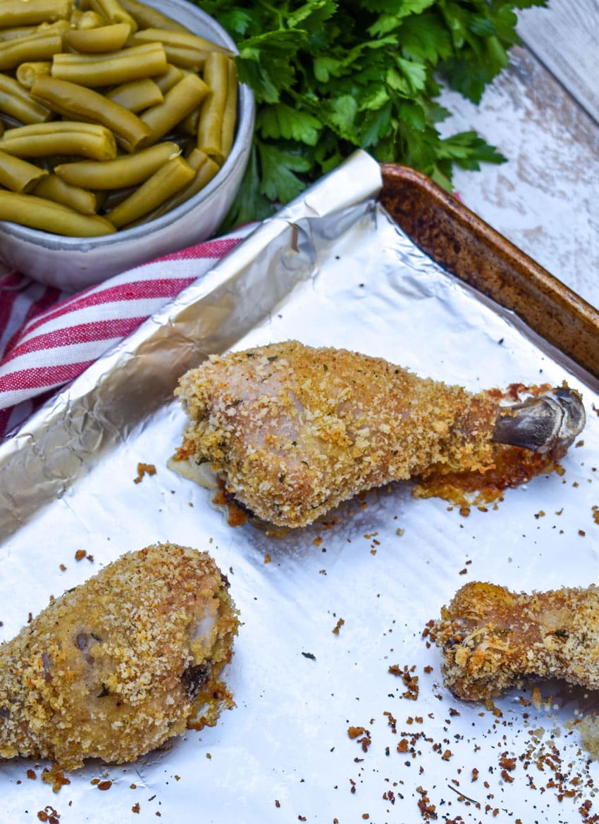 HOMEMADE SHAKE AND BAKE CHICKEN LEGS ON A FOIL LINED BAKING SHEET