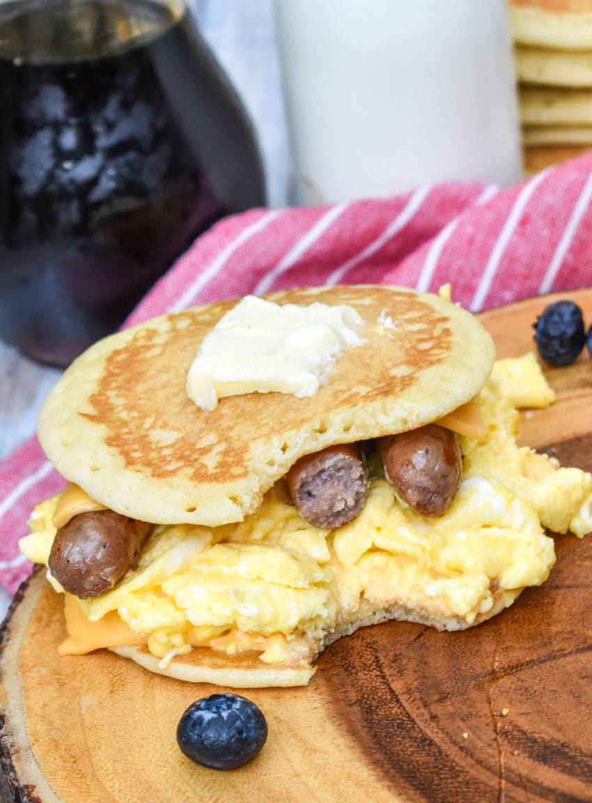 pancake egg and cheese sandwiches on a wooden cutting board