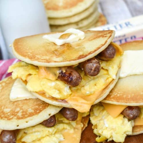 pancake egg and cheese sandwiches on a wooden cutting board