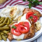 skillet balsamic chicken next to mashed potatoes and canned green beans on a white plate