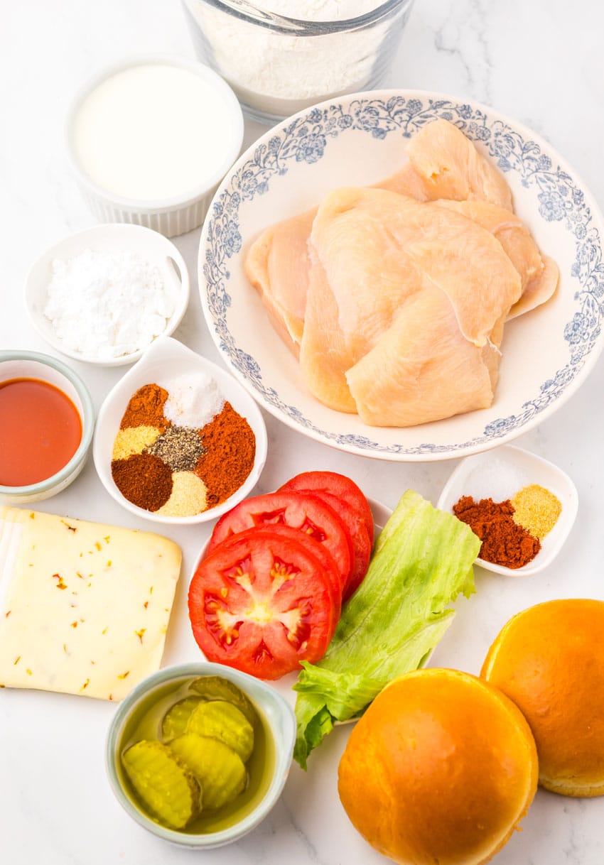 an overhead image showing the measured ingredients needed to make a a copycat Chick Fil A spicy deluxe sandwich