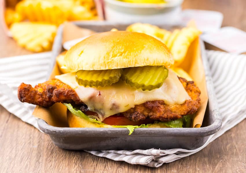 a copycat Chick Fil A spicy deluxe sandwich on a metal tray