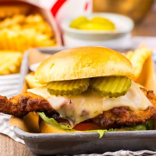 a copycat Chick Fil A spicy deluxe sandwich on a metal tray
