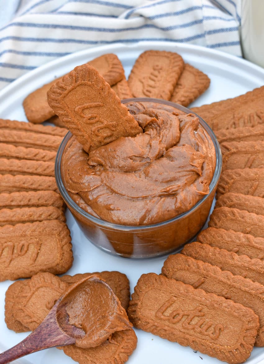 homemade creamy cookie butter in a small glass bowl surrounded by biscoff cookies