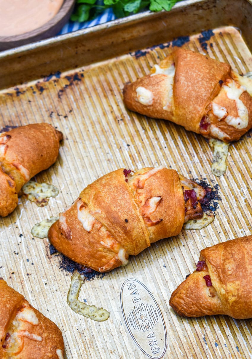 reuben crescent rolls on a metal baking sheet pan