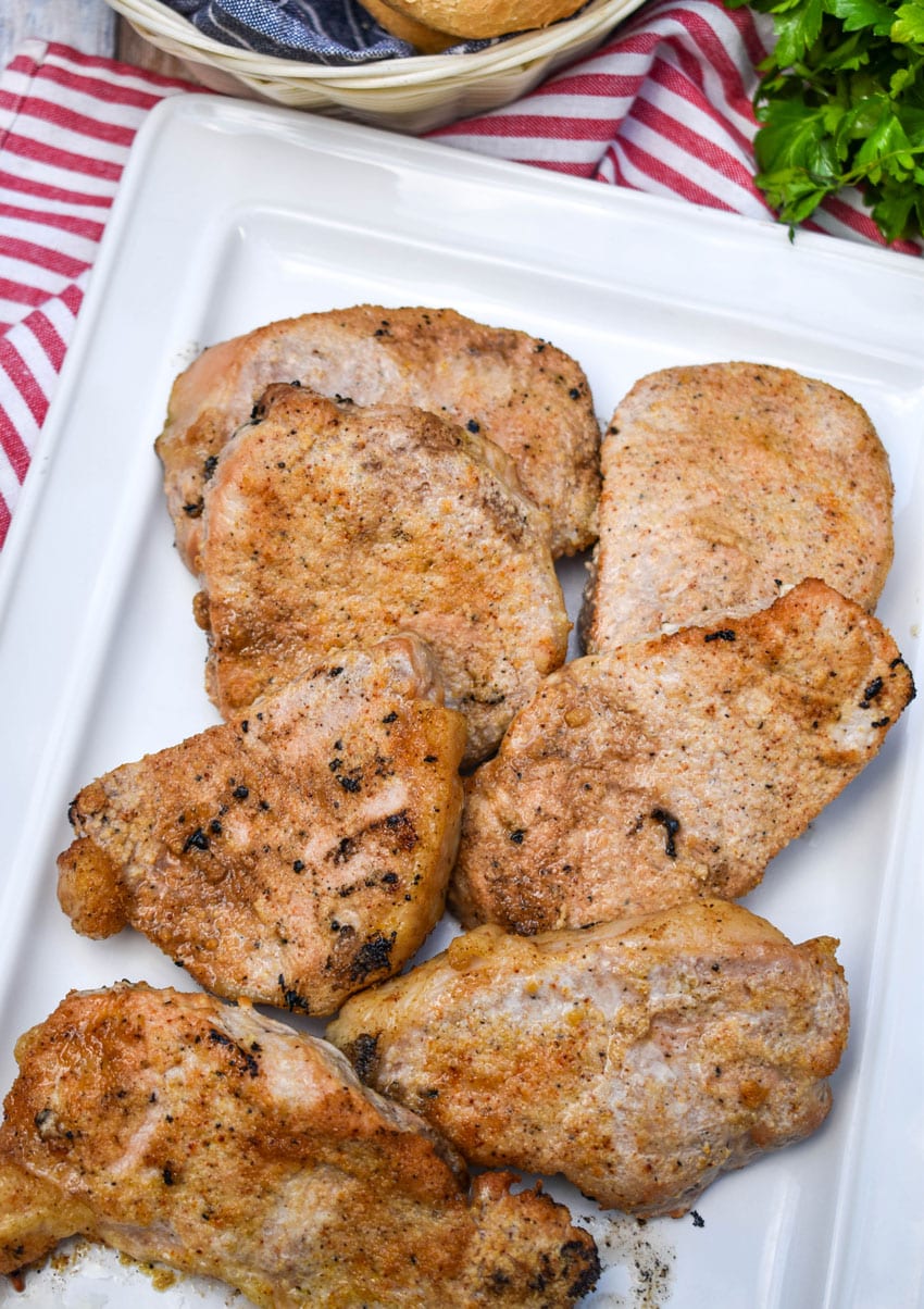 smoked pork chops on a white serving platter