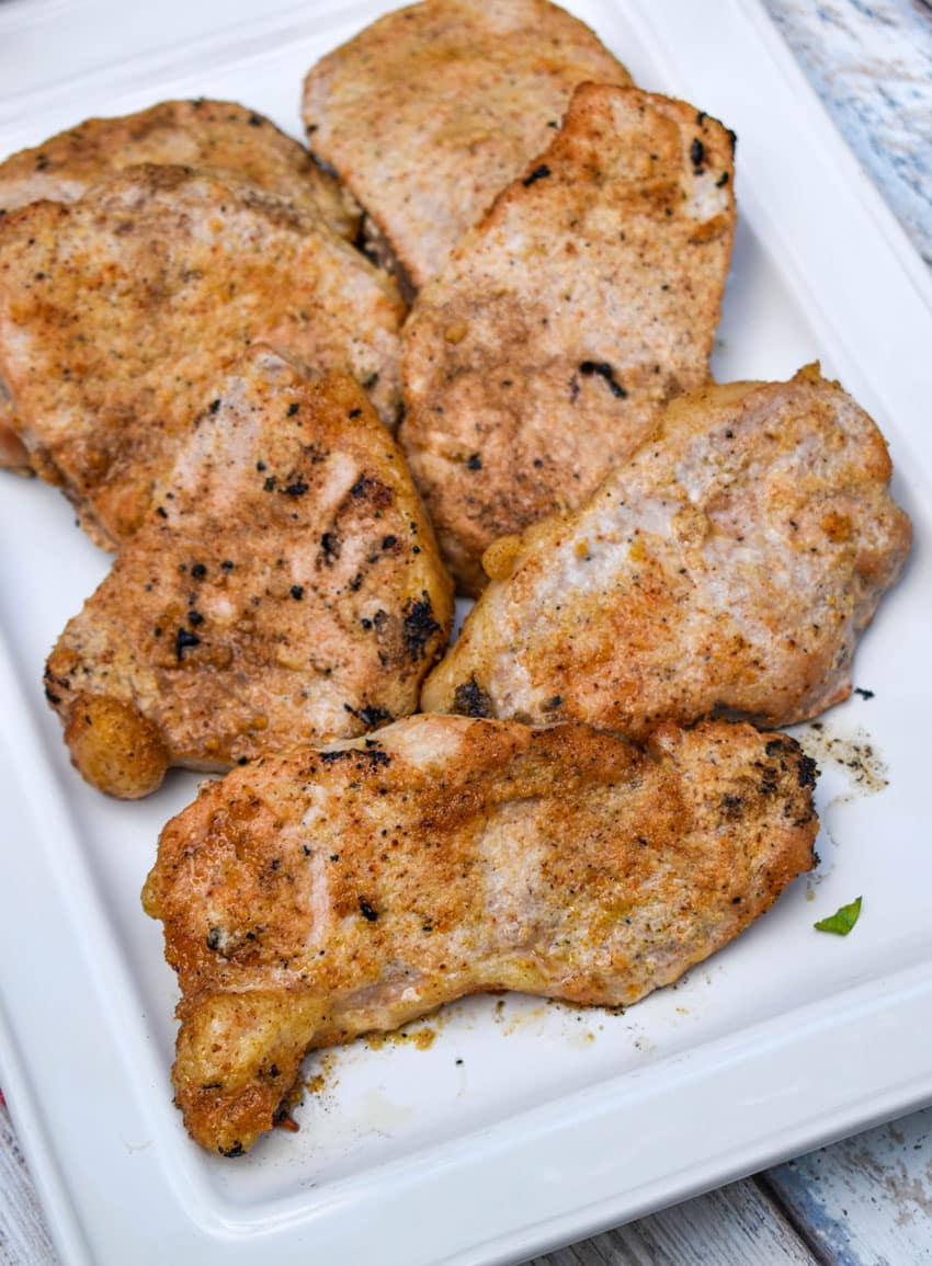smoked pork chops on a white serving platter