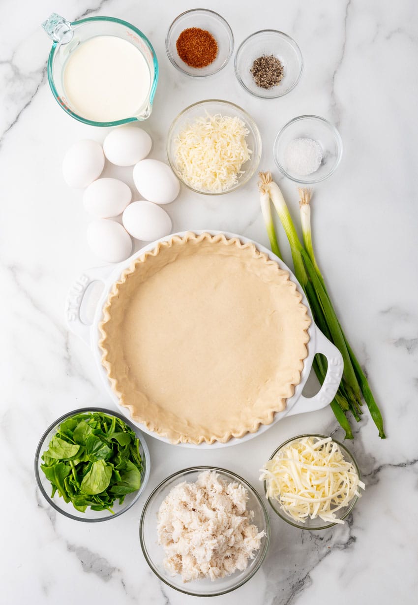 an overhead image showing the measured ingredients needed to make a homemade crab quiche