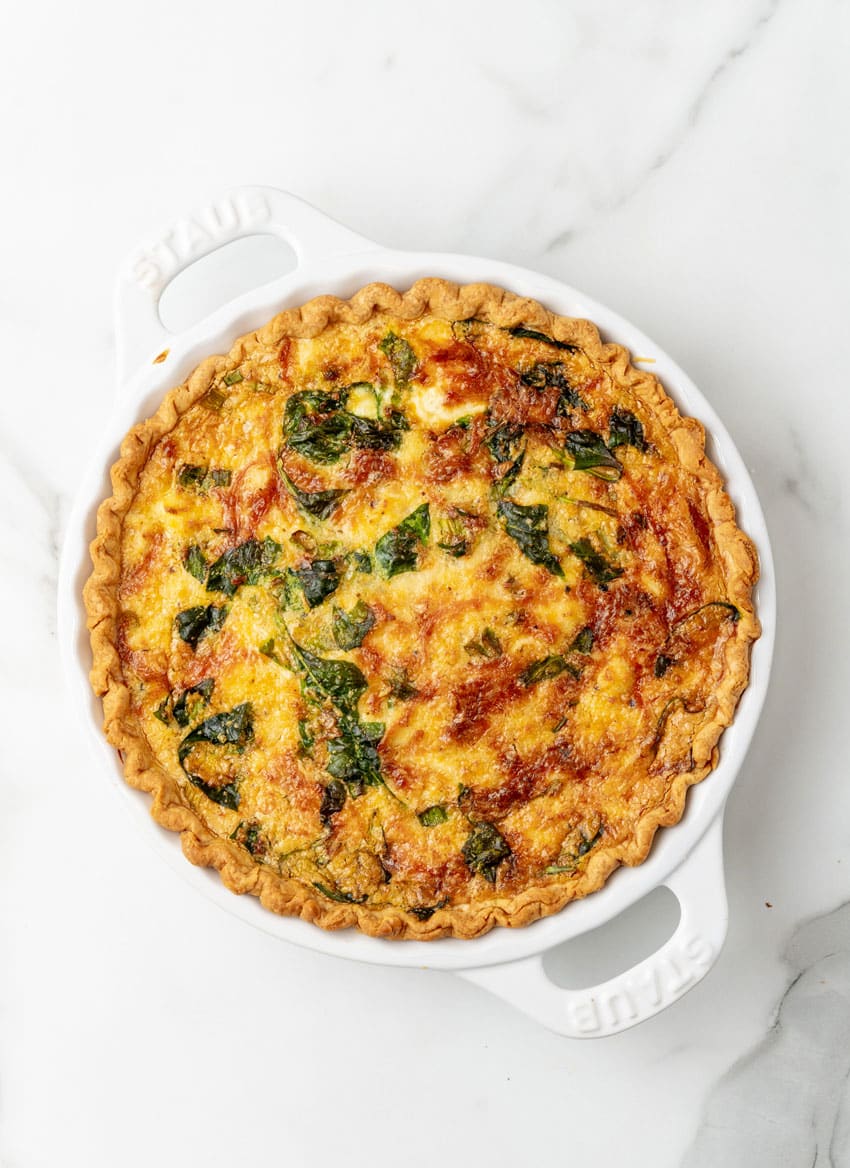 a baked crab quiche on a marble countertop