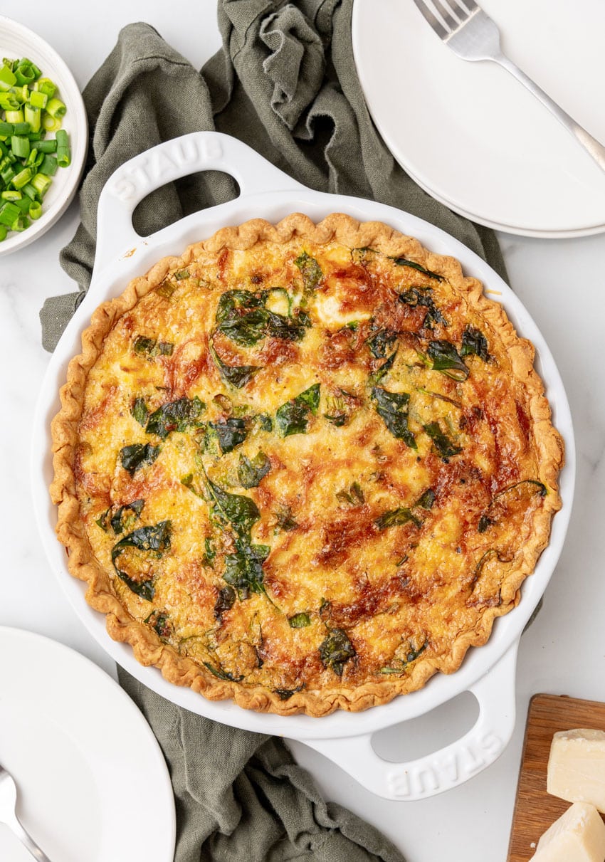 a baked crab quiche on a marble countertop