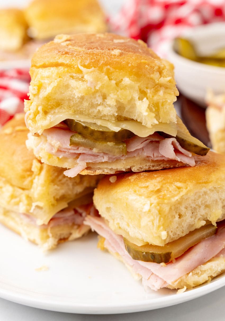 a stack of cuban style sliders on a white plate