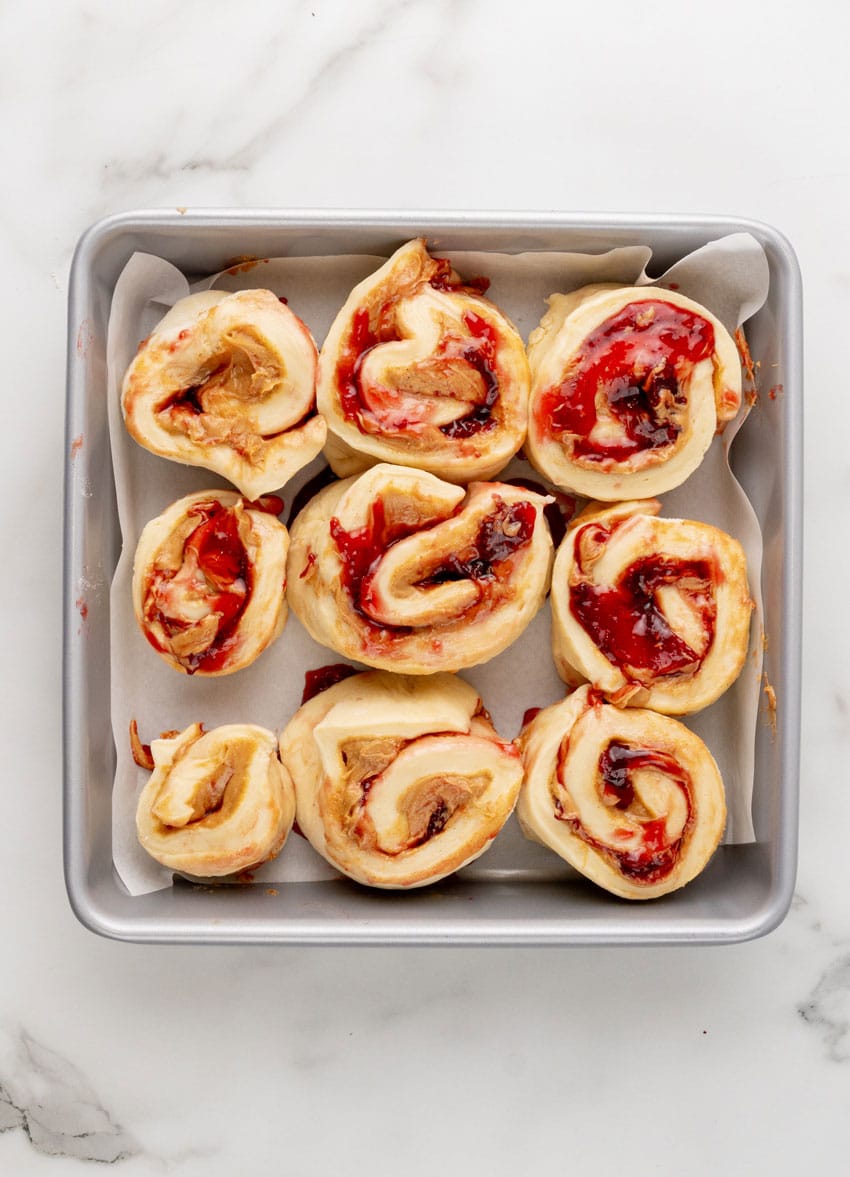 peanut butter and jelly sweet rolls in a metal baking pan