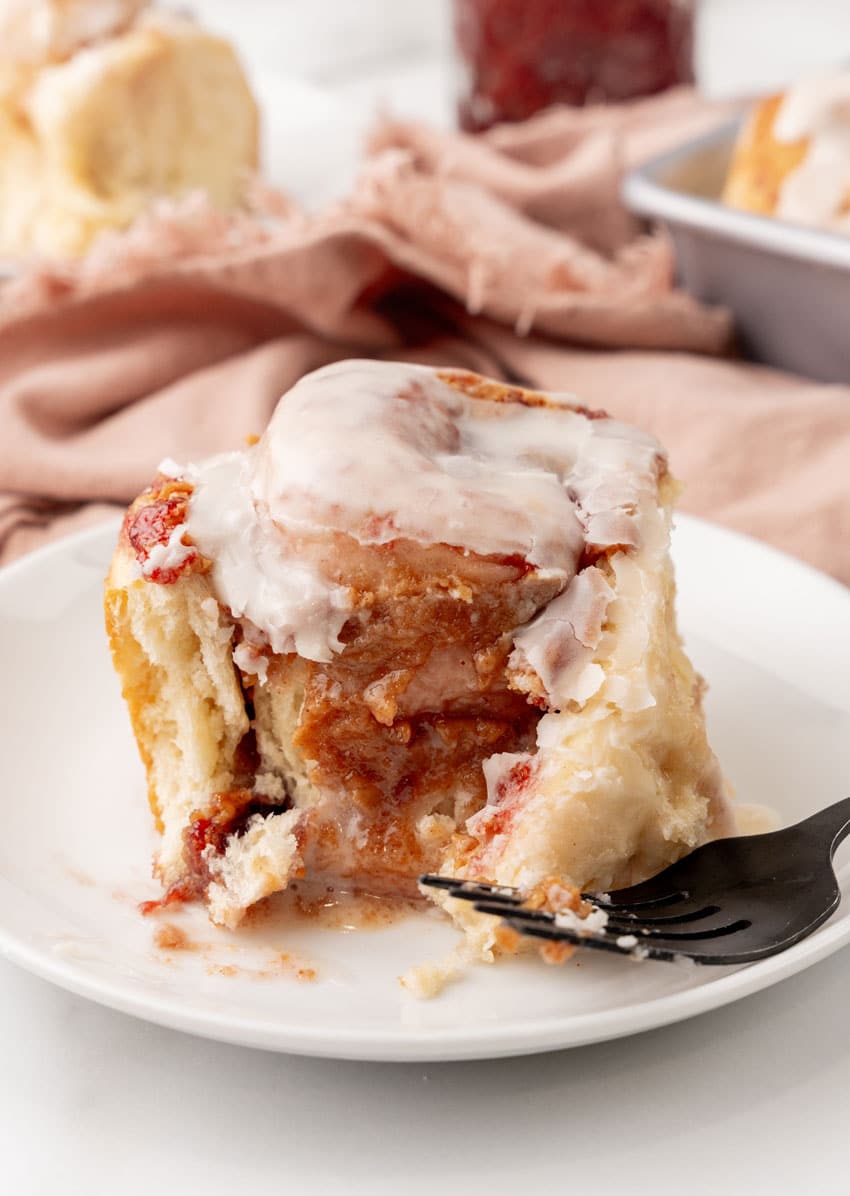 a peanut butter and jelly roll on a small white dessert plate