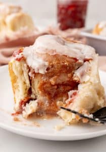 a peanut butter and jelly roll on a small white dessert plate