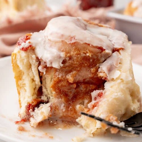 a peanut butter and jelly roll on a small white dessert plate