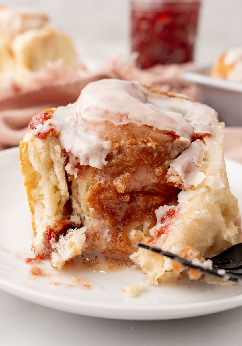 a peanut butter and jelly roll on a small white dessert plate