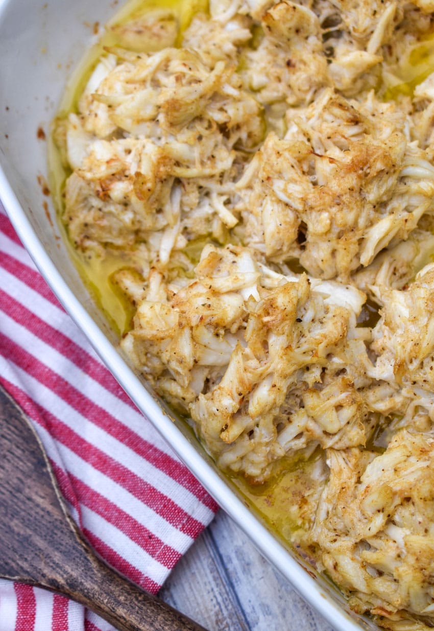 baked lump crab cakes in butter in a white casserole dish